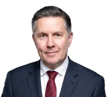A person in a suit and tie

AI-generated content may be incorrect.
